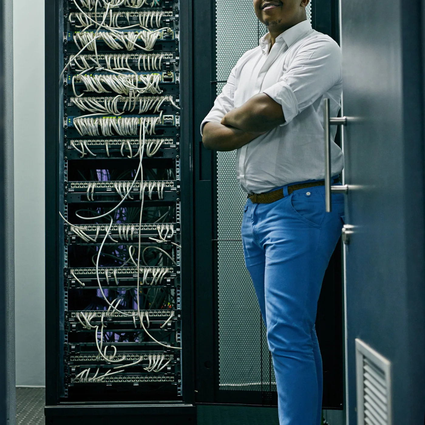 African IT support specialist working inside a server room